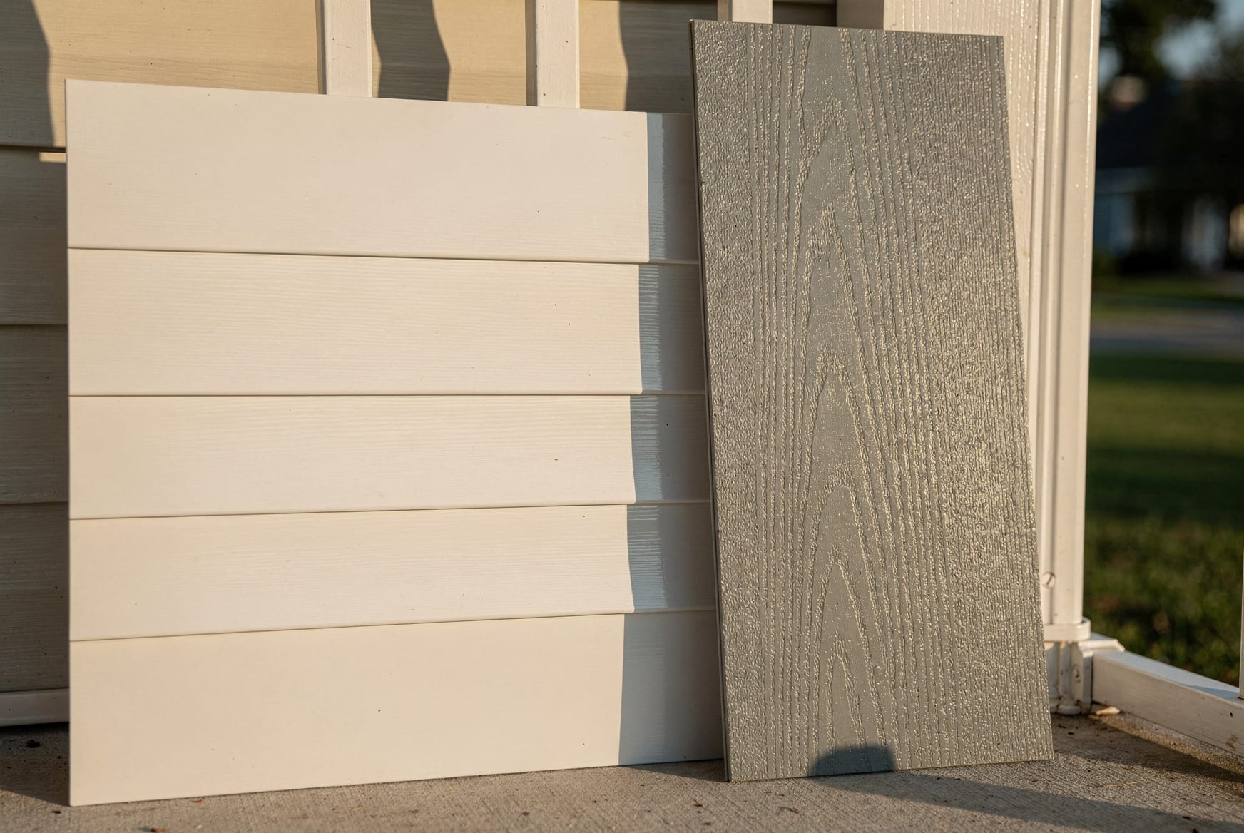 The exterior corner of a North Carolina home showing clean horizontal lap siding in warm afternoon daylight.